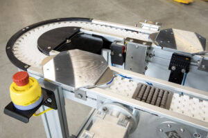 two workpiece carrier systems on conveyor belt